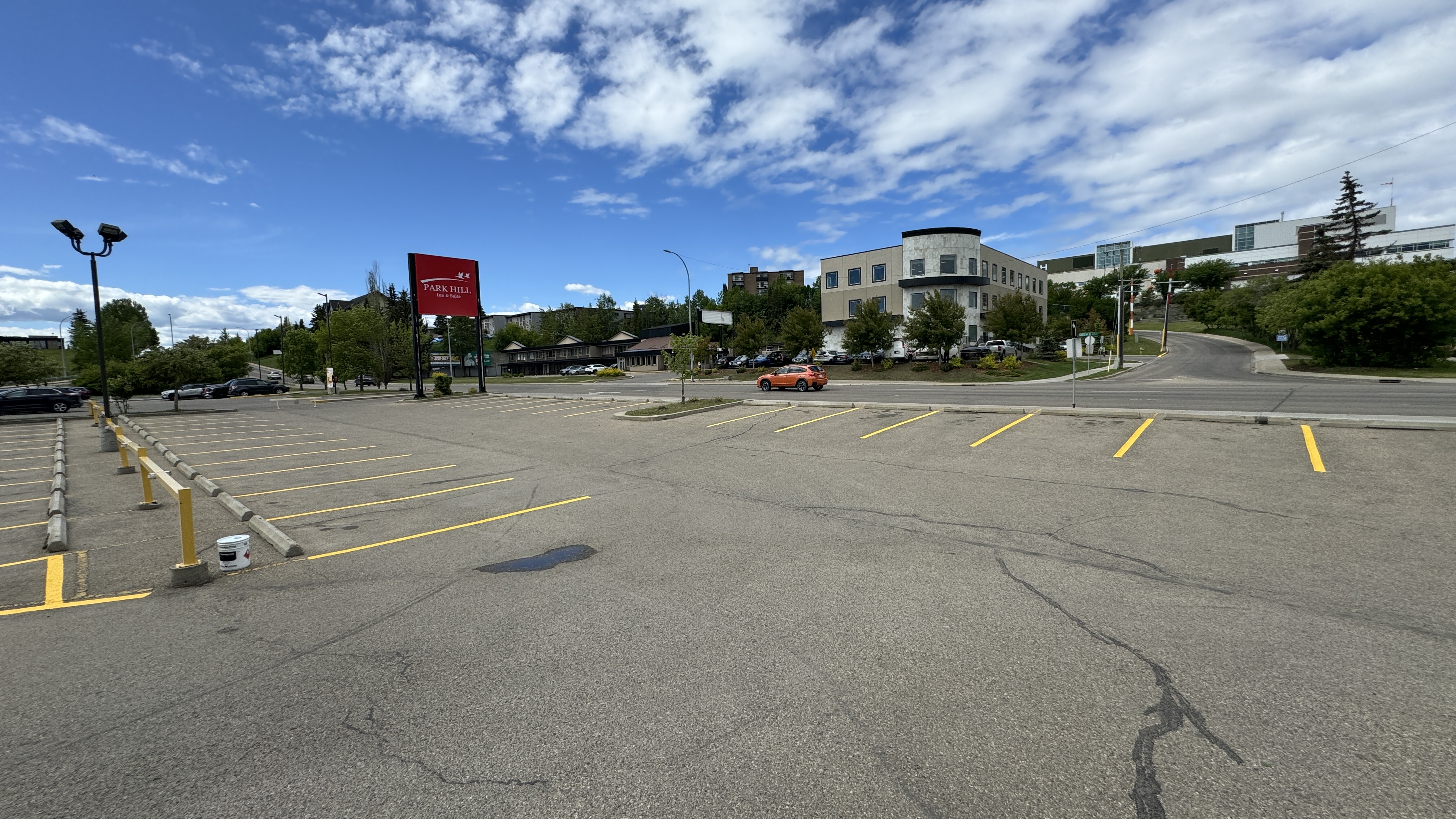 Wide view of commercial parking lot after line painting — Park Hill Inn, Red Deer