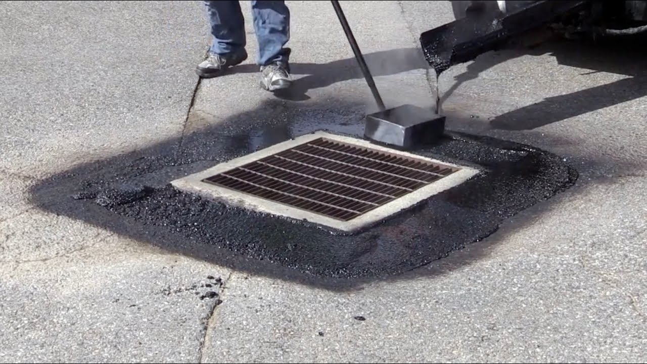 Commercial hot mastic asphalt repair around a catch basin
