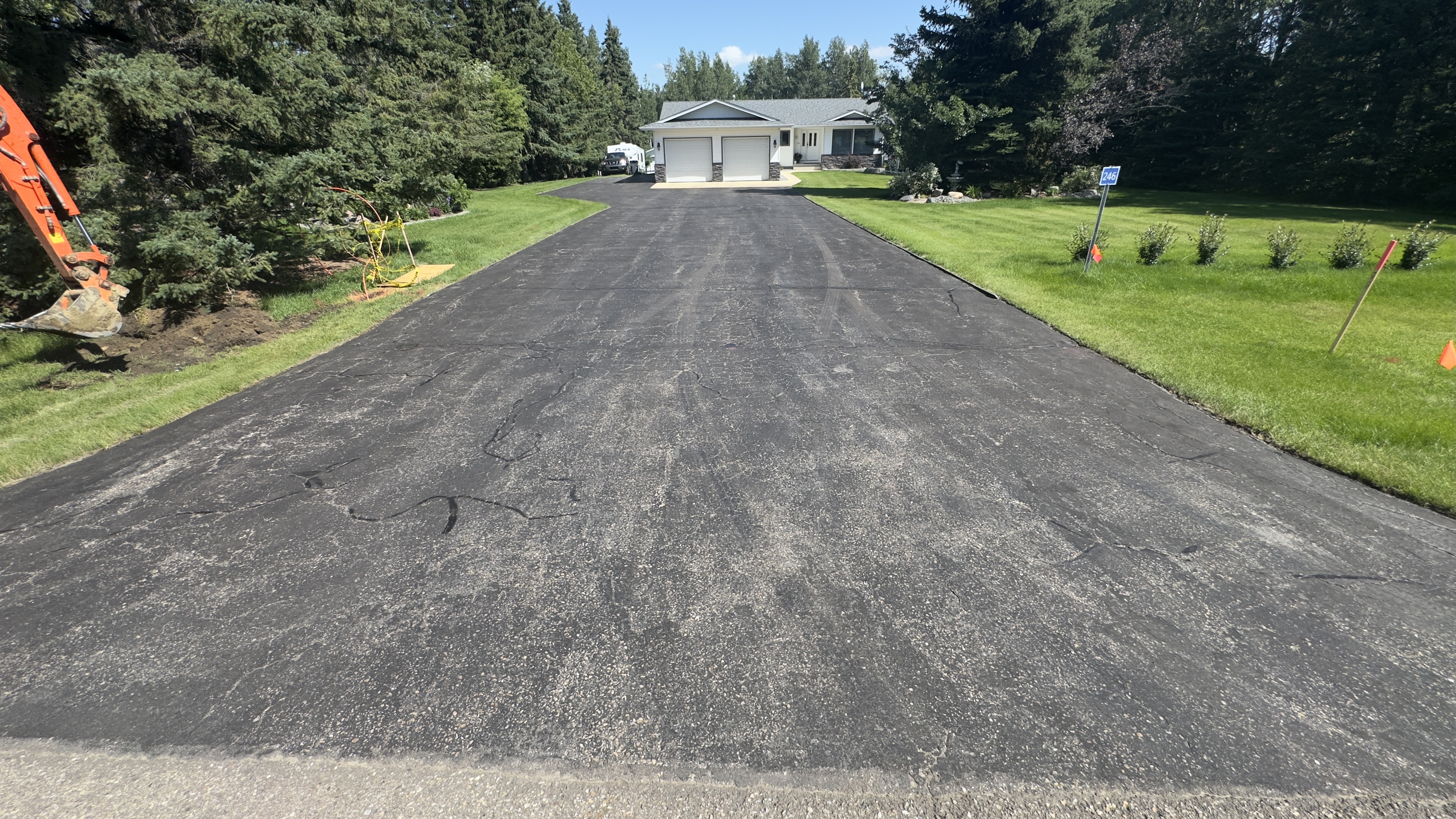 Faded driveway before sealcoating in Red Deer County